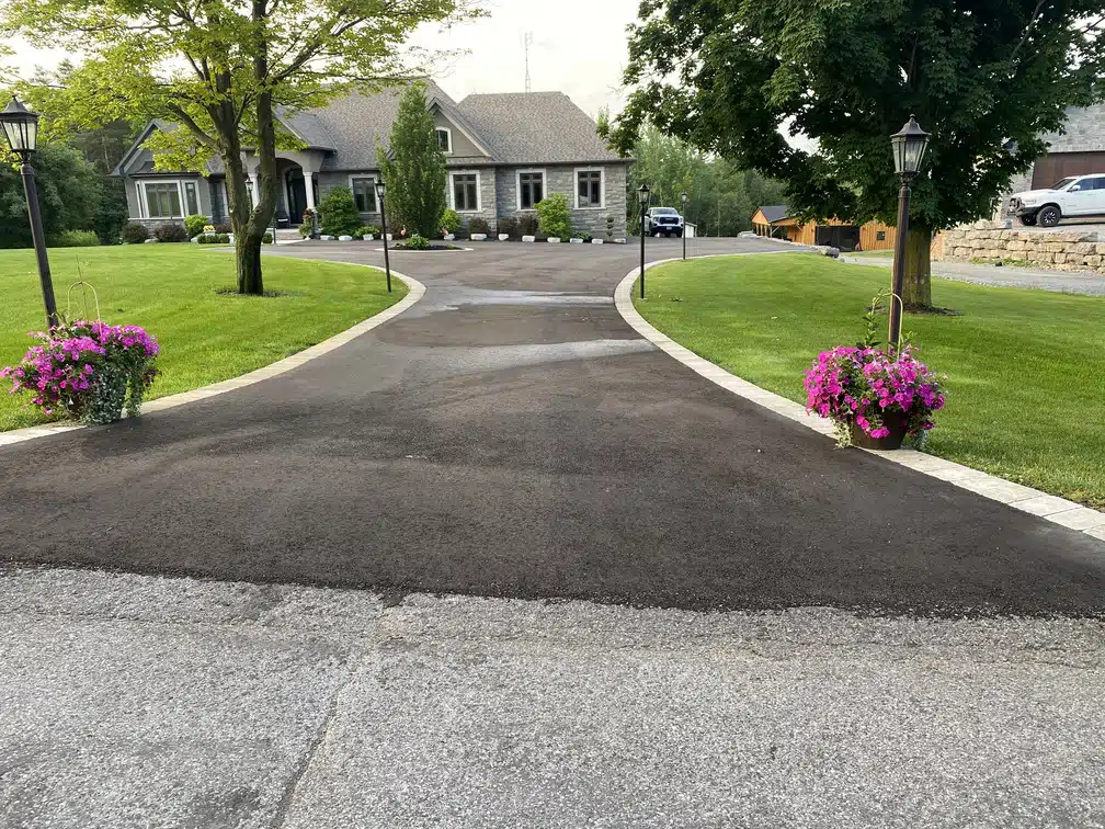 Finished interlock paving on a residential driveway with intricate design in Oshawa, ON.