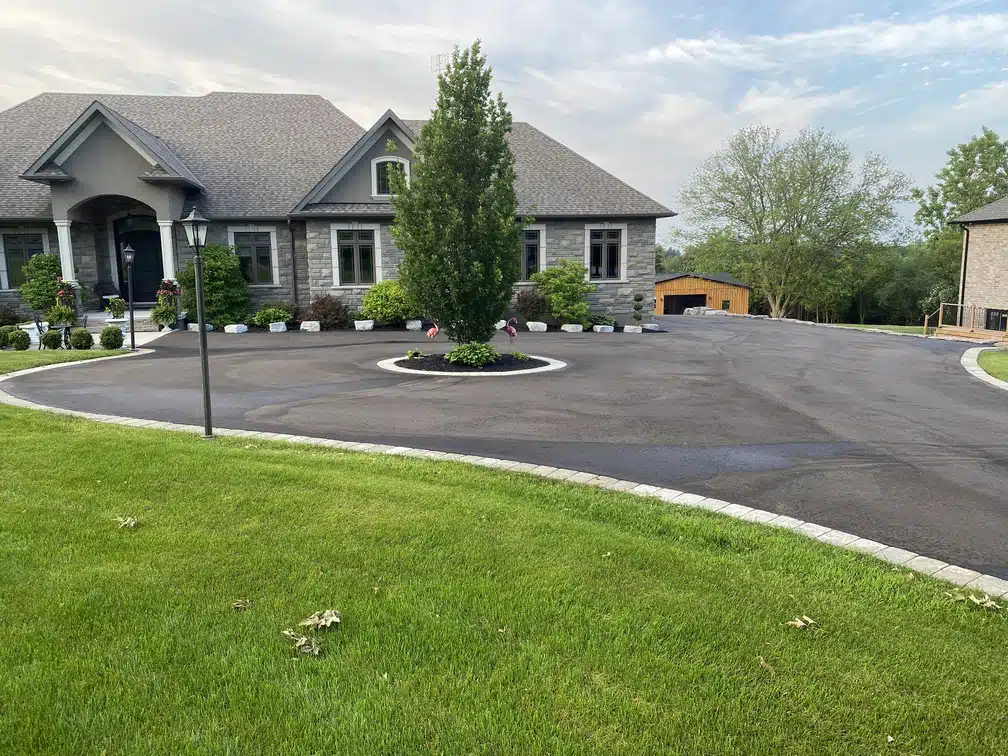 Finished interlock paving and edging on a residential driveway in Oshawa, ON.