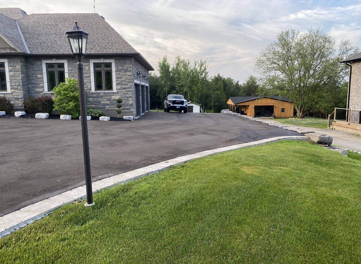 Newly paved asphalt residential driveway by C. Aurora Paving in Whitby, Ontario
